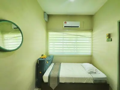 a small bedroom with a bed and a mirror at Ipoh Tambun pool villa 5br20pax bbq karaoke mahjong in Ipoh