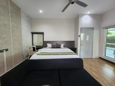 a bedroom with a large bed and a ceiling fan at Ipoh Tambun pool villa 5br20pax bbq karaoke mahjong in Ipoh