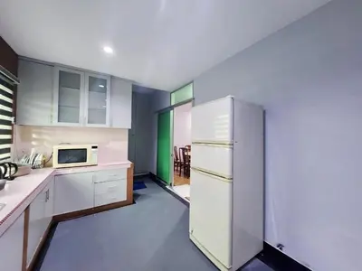 a kitchen with white cabinets and a white refrigerator at Ipoh Tambun pool villa 5br20pax bbq karaoke mahjong in Ipoh
