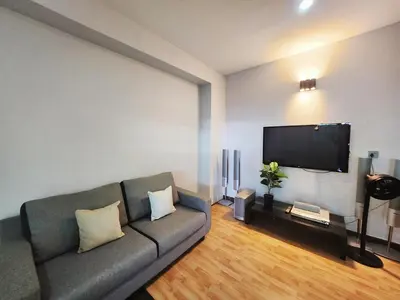 a living room with a couch and a flat screen tv at Ipoh Tambun pool villa 5br20pax bbq karaoke mahjong in Ipoh