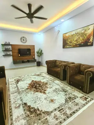a living room with a couch and a flat screen tv at Homestay Segari in Lumut