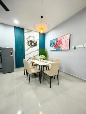 a dining room with a table and chairs at Homestay Segari in Lumut