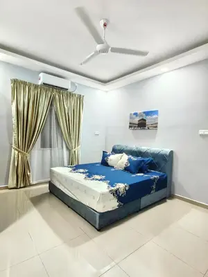 a blue bed in a room with a ceiling at Homestay Segari in Lumut
