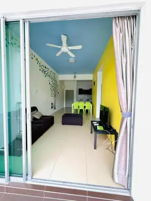 a living room with a couch and a ceiling fan at Homestay Golden Hills in Brinchang