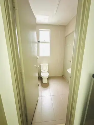 a bathroom with a toilet and a window at Homestay Golden Hills in Brinchang