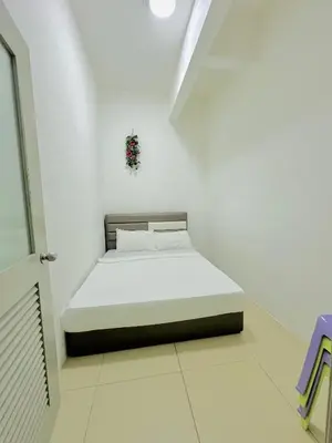 a bedroom with a bed in a white room at Homestay Golden Hills in Brinchang