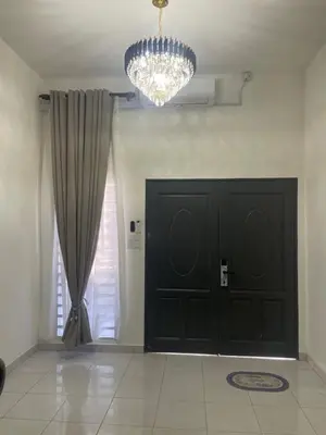 a room with a black door and a chandelier at Homestay Cikgu Ina in Kampong Chepor