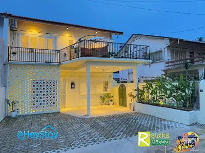 a large white house with a balcony on top of it at MalayaVilla 5R3B16Pax PrivatePool Karaok PlayGround in Gua Sai