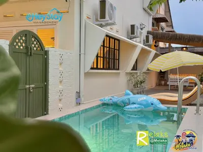 a pool at a resort with a shark in the water at MalayaVilla 5R3B16Pax PrivatePool Karaok PlayGround in Gua Sai