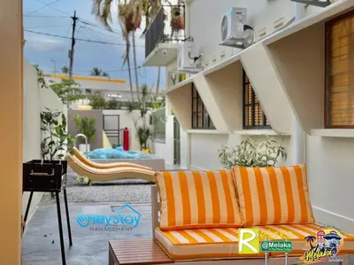 a couch sitting on the side of a building at MalayaVilla 5R3B16Pax PrivatePool Karaok PlayGround in Gua Sai