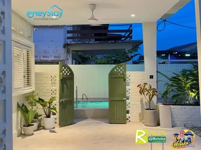 a villa with a swimming pool and two green doors at MalayaVilla 5R3B16Pax PrivatePool Karaok PlayGround in Gua Sai