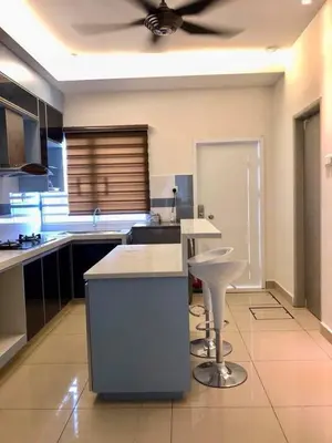 a kitchen with a ceiling fan and a table and stool at Casa Innova Homestay, Bertam Penang in Kepala Batas