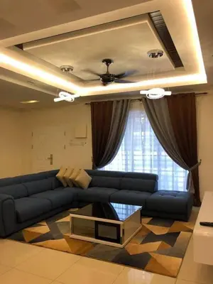 a living room with a blue couch and a table at Casa Innova Homestay, Bertam Penang in Kepala Batas