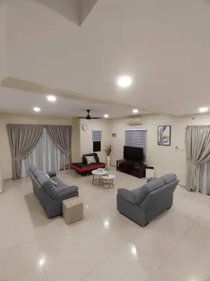 a living room with two couches and a television at Ipoh Calm Corner in Ipoh
