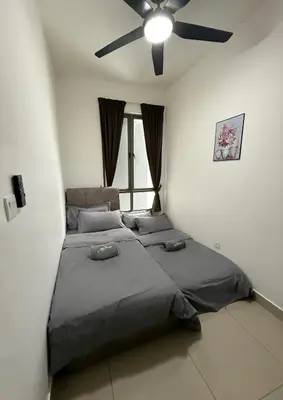 a bedroom with two beds and a ceiling fan at Palas Horizon Home A-6-15 in Brinchang
