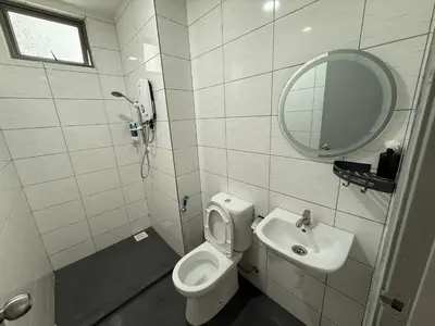 a bathroom with a toilet and a sink and a mirror at Palas Horizon Home A-6-15 in Brinchang