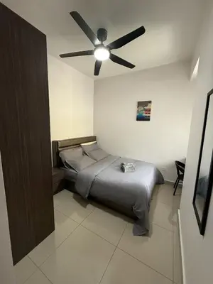 a bedroom with a bed with a ceiling fan at Palas Horizon Home A-6-15 in Brinchang