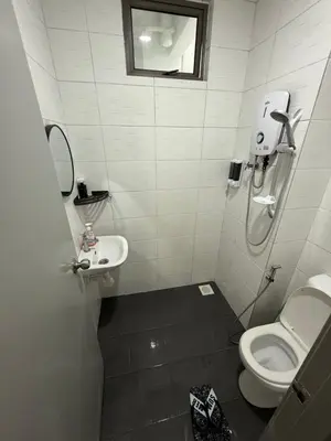 a bathroom with a toilet and a sink at Palas Horizon Home A-6-15 in Brinchang