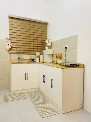 a kitchen with white cabinets and a sink at NAZS Homestay 4 bilik tidur 3 bilik air in Sungai Petani