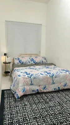a bedroom with a bed and a rug at Aurora Inap Stay for Mslim Only in Cameron Highlands