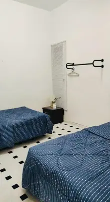 a bedroom with two beds and a black and white floor at Aurora Inap Stay for Mslim Only in Cameron Highlands