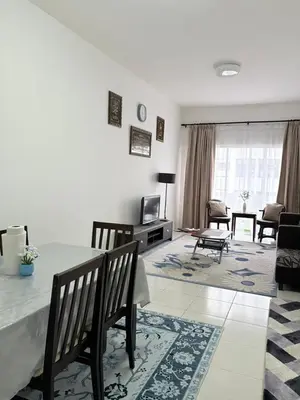 a living room with a table and chairs and a television at Aurora Inap Stay for Mslim Only in Cameron Highlands