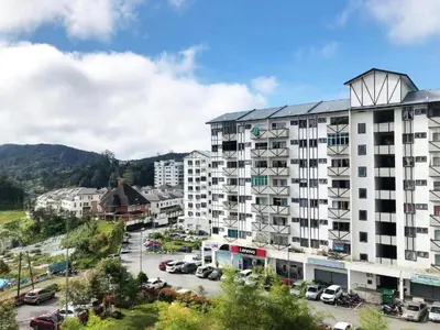 an apartment building in a city with a parking lot at Aurora Inap Stay for Mslim Only in Cameron Highlands