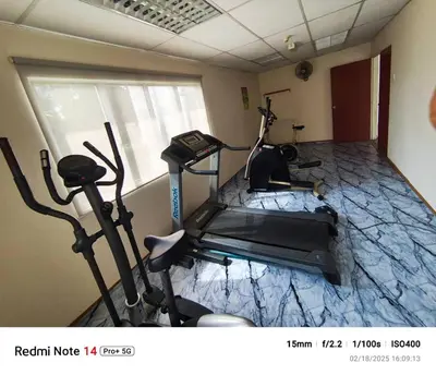 a gym with two exercise bikes in a room at Railway Hostel in Batu Gajah