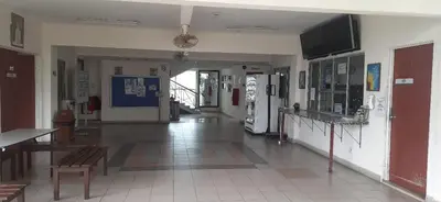 an empty hallway of a building with a room with at Railway Hostel in Batu Gajah