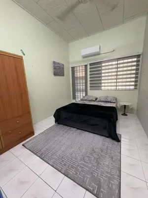 a bedroom with a bed and a large rug at Nadis Guesthouse in Ipoh