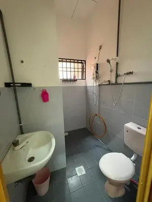 a bathroom with a toilet and a sink at Nadis Guesthouse in Ipoh