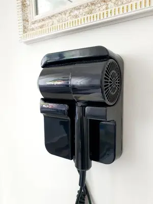 a black wall mounted air conditioner on a wall at Awan Homestay Cameron Highlands in Tanah Rata