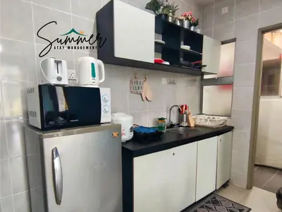 a small kitchen with a refrigerator and a microwave at CAMERON HIGHLAND Homestay 1 min To Pasar Malam Brinchang By SummerStay 4 - 5pax in Brinchang
