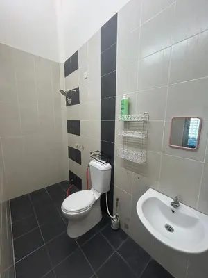 a bathroom with a toilet and a sink at Homestay Stop in Gua Sai
