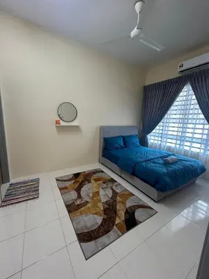 a bedroom with a blue bed and a large window at Homestay Stop in Gua Sai