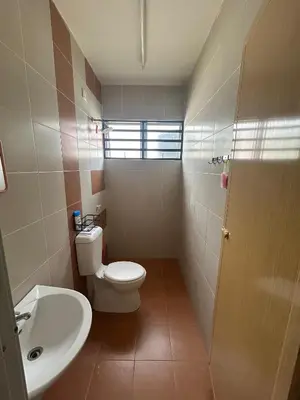 a bathroom with a toilet and a sink at Homestay Stop in Gua Sai