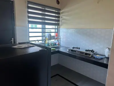 a kitchen with a stove and a counter top at Homestay Stop in Gua Sai