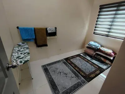 a bathroom with towels and a stool and a door at Homestay Stop in Gua Sai