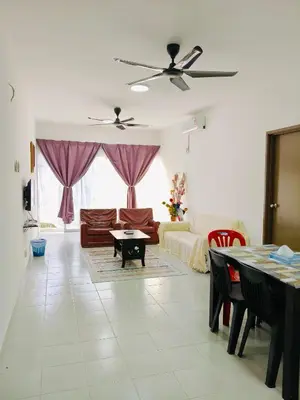 a living room with a couch and a table at Ryhan-Cha Homestay near Afamosa Waterpark in Gua Sai