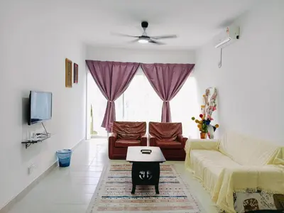 a living room with a couch and a table at Ryhan-Cha Homestay near Afamosa Waterpark in Gua Sai