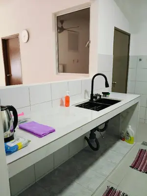 a bathroom counter with a sink and a mirror at Ryhan-Cha Homestay near Afamosa Waterpark in Gua Sai
