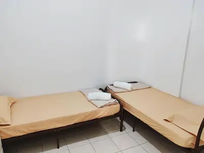 two beds sitting next to each other in a room at Pangkor Lot10 Vacation Studio in Pangkor