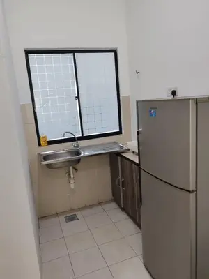 a kitchen with a sink and a refrigerator at Pangkor Lot10 Vacation Studio in Pangkor