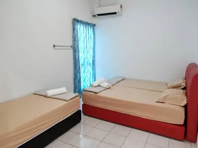two beds sitting next to each other in a room at Pangkor Lot10 Vacation Studio in Pangkor