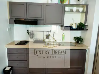 a kitchen with white cabinets and a sink at Luxury Dream Seaview in Tanjung Bungah