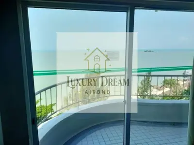 a reflection of a building in the window of a building at Luxury Dream Seaview in Tanjung Bungah