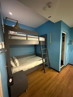 two bunk beds in a room with blue walls at Embassy Hotel Georgetown in George Town