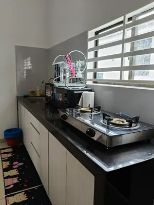 a kitchen with a counter top with a stove at Bertam Perdana Homestay