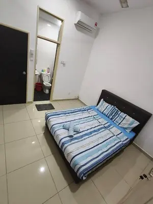 a bed sitting in a room with a mirror at Bertam Perdana Homestay