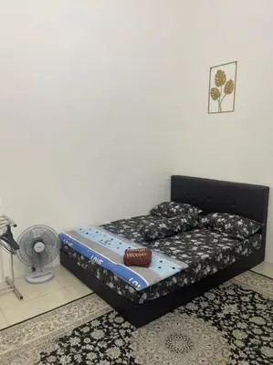 a small bed in a room with a bed sqor at The Indah Homestay Gerik in Gerik